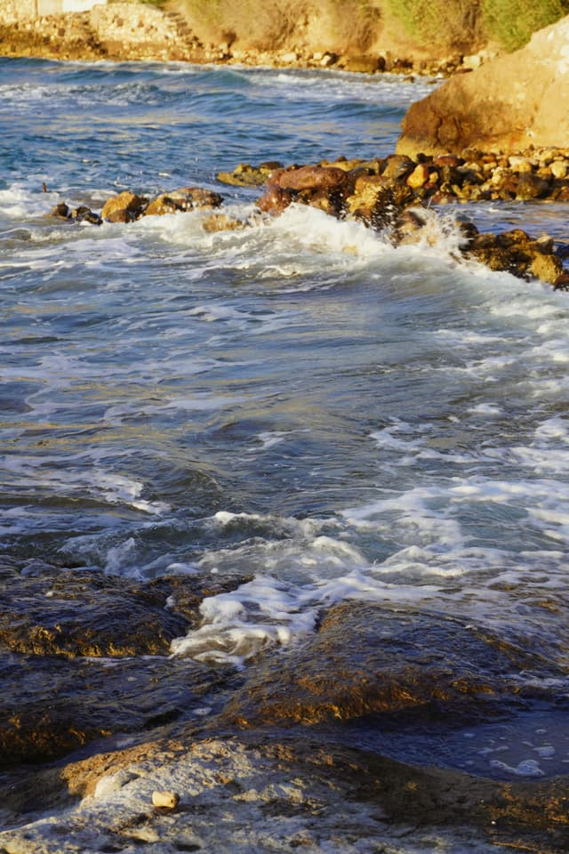 Surfer catching a wave at sunset